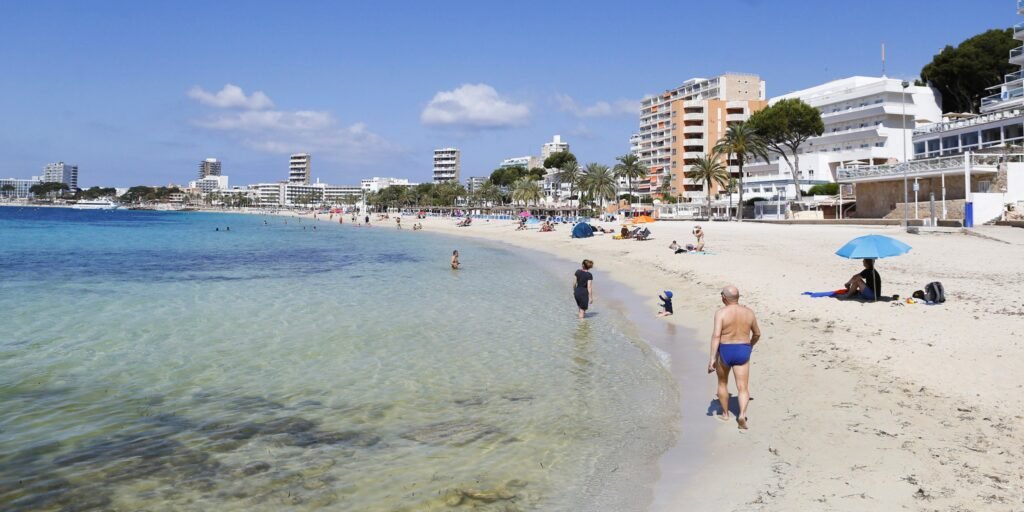 travel restriction -People sunbathe at Magaluf beach in Mallorca