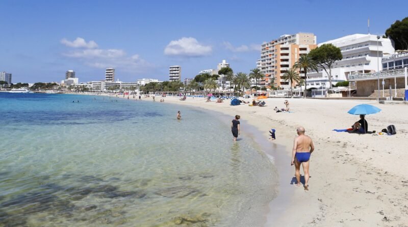 travel restriction -People sunbathe at Magaluf beach in Mallorca