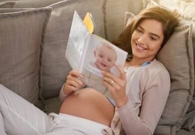 Woman,,Happiness,And,Pregnancy,Book,On,Couch,For,Research,,Planning